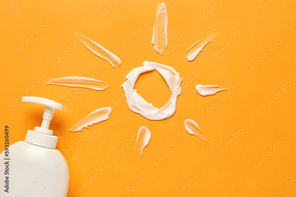 Sun made of cream with sunscreen on color background