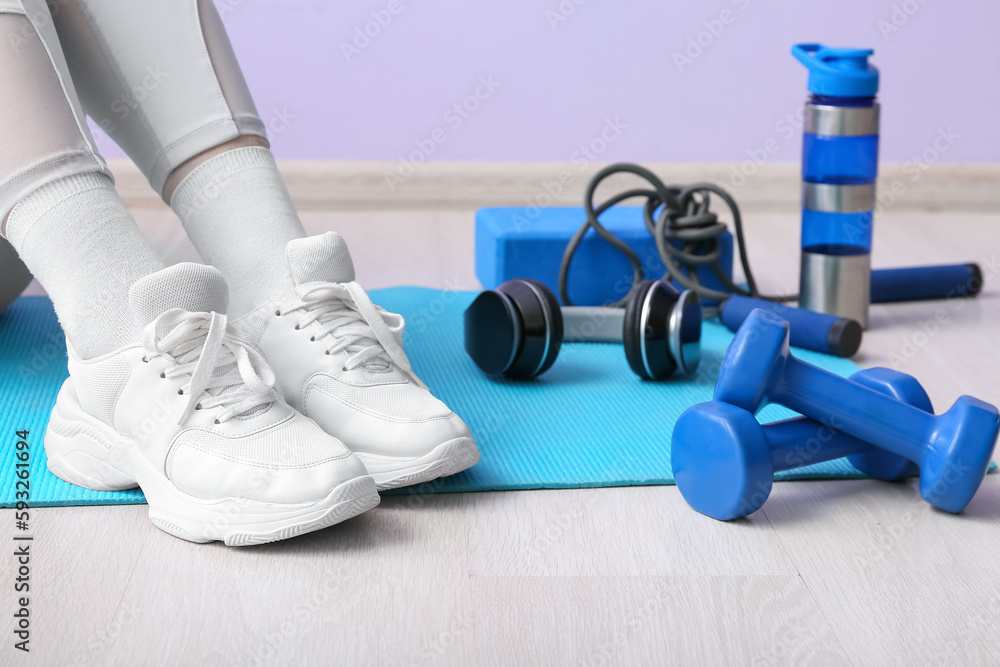 Woman with sports equipment in gym, closeup