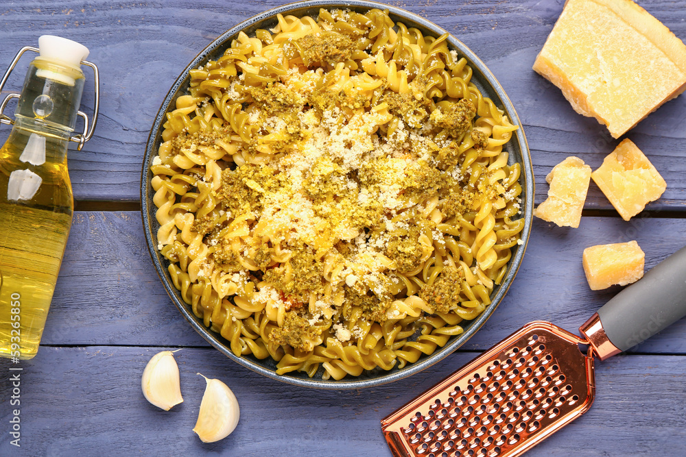 Plate of tasty Italian pasta with Parmesan cheese on wooden background