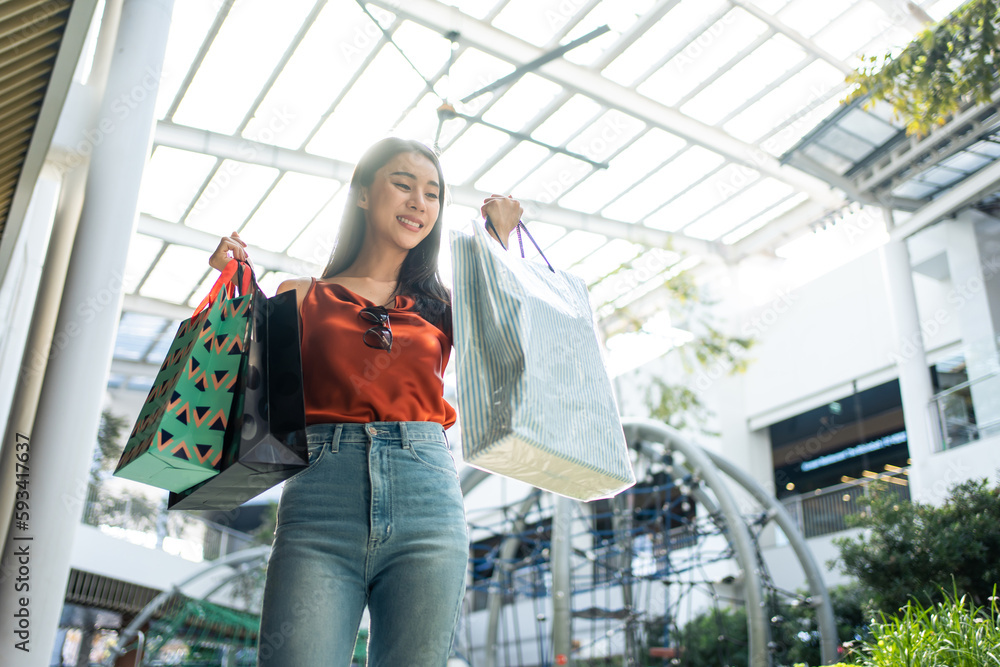 Asian beautiful woman shopping goods outdoor alone in department store. 