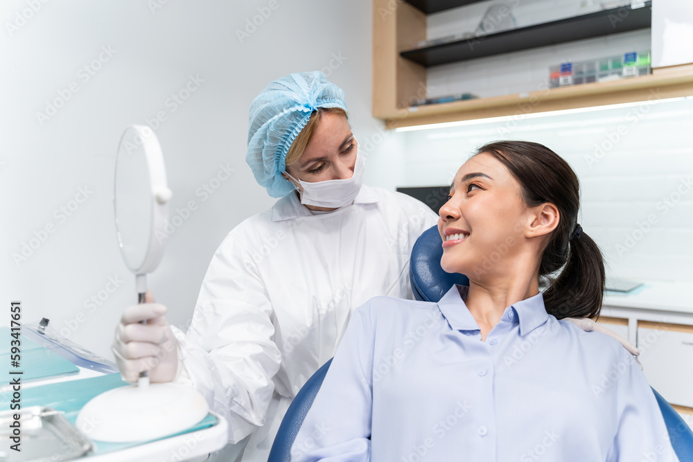 Caucasian dentist examine tooth for young girl at dental health clinic. 