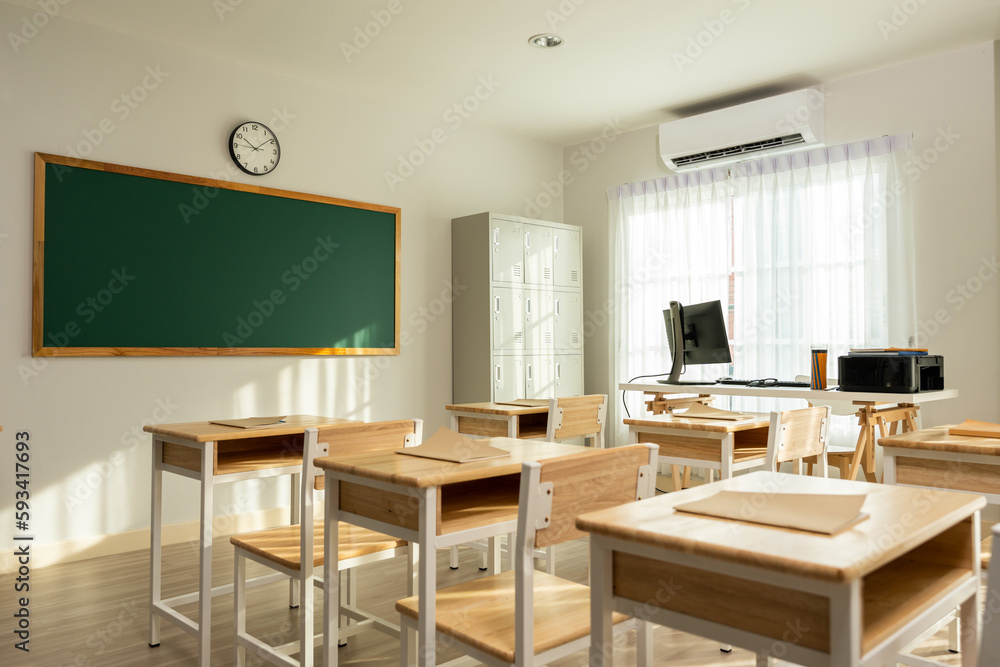 Shot of empty classroom with chairs under desks in elementary school. 