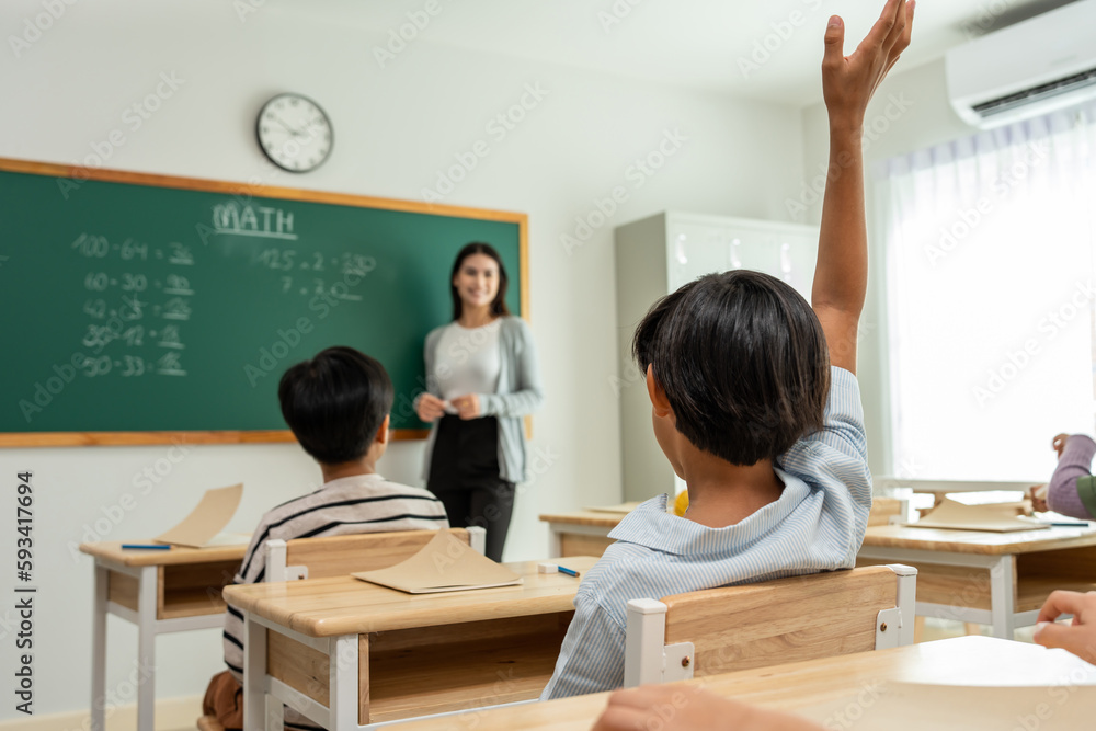 Group of student learn with teacher in classroom at elementary school. 