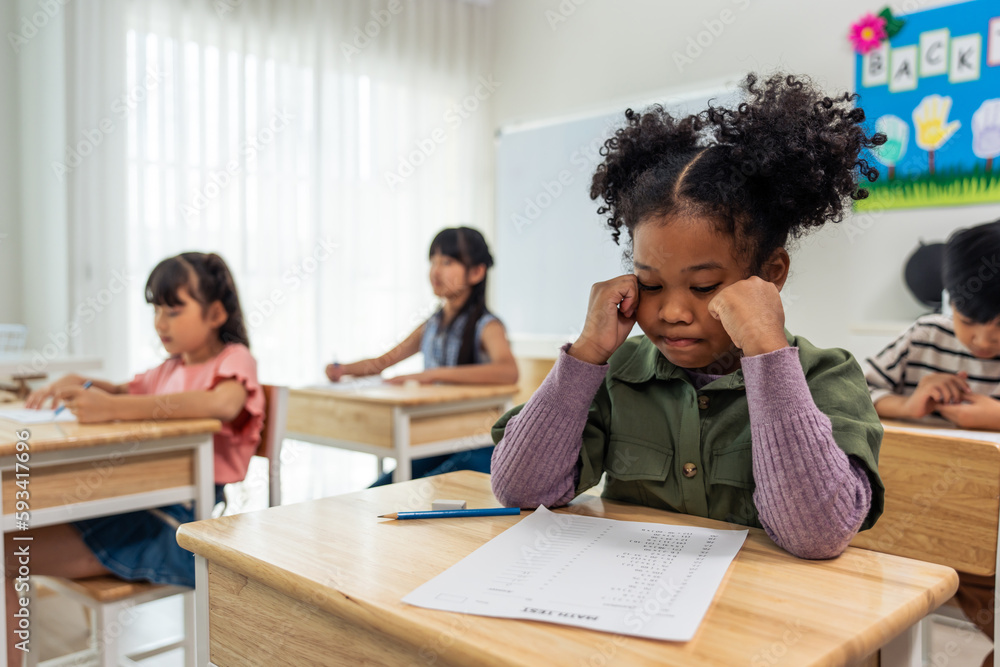 African American black girl student doing an exam at elementary school. 