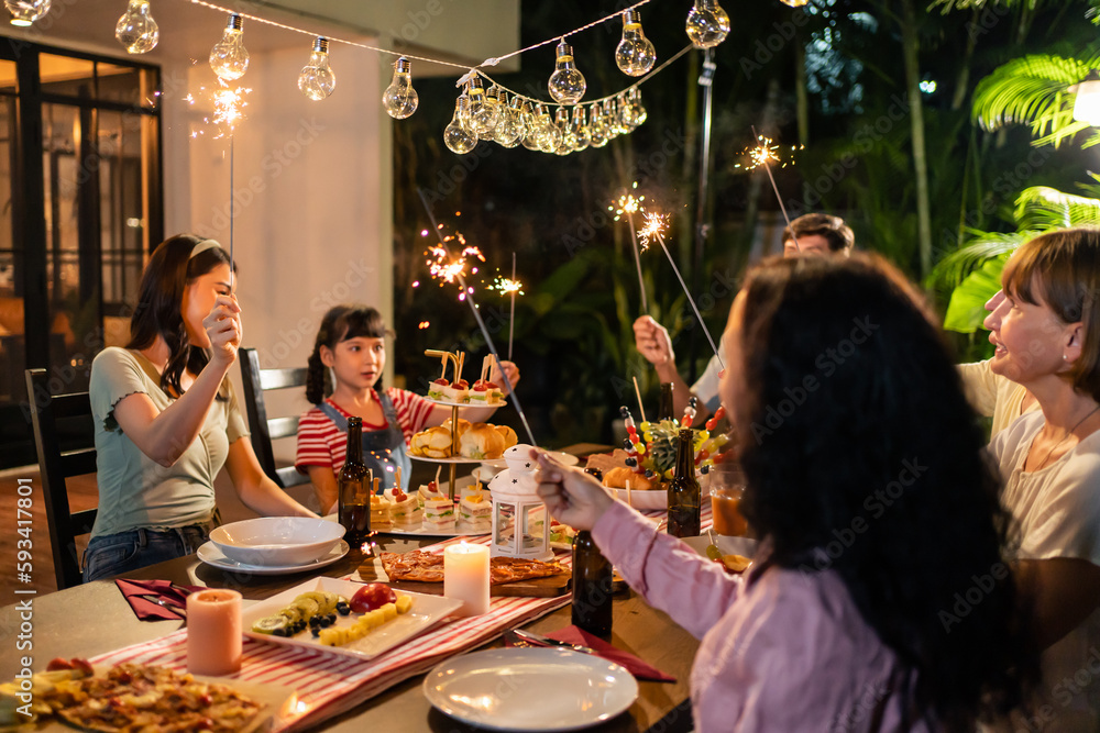 Multi-ethnic big family having fun, enjoy party outdoors in the garden. 