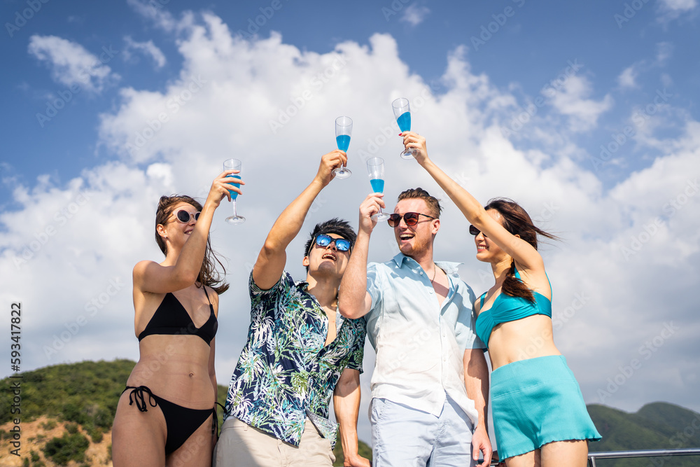 Group of diverse friends drink champagne while having a party in yacht. 