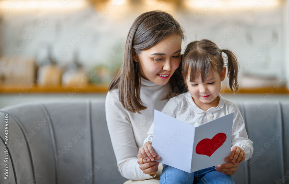 Daughter giving mother postcard