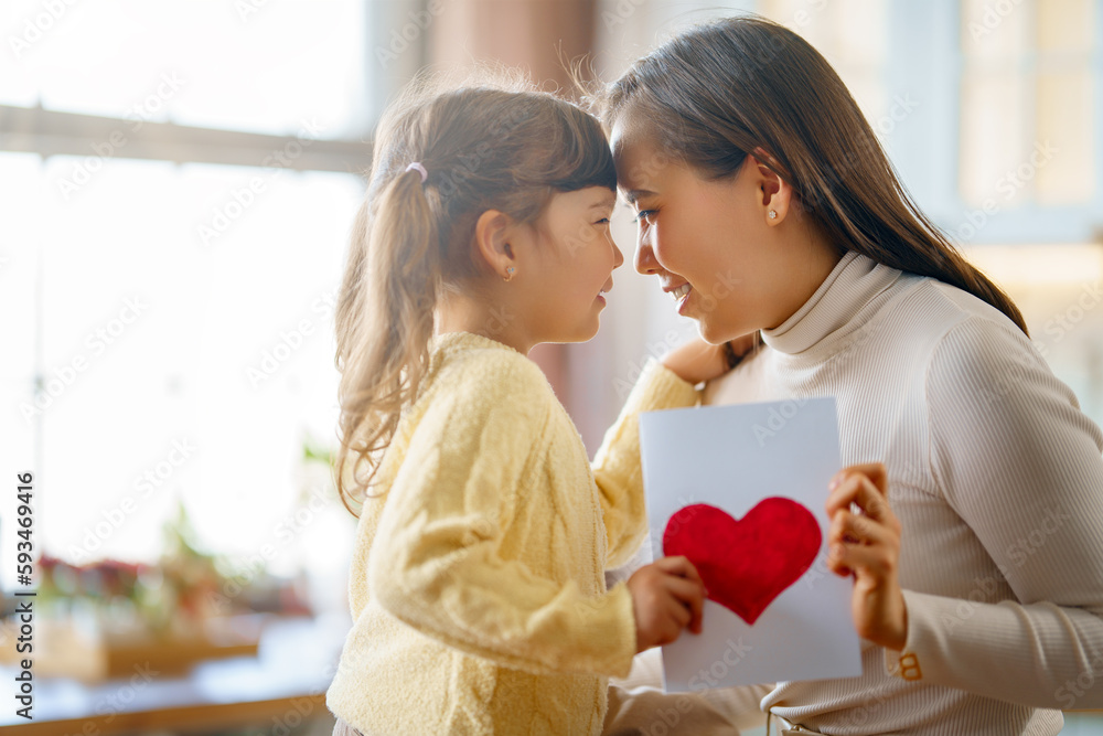 Daughter giving mother postcard