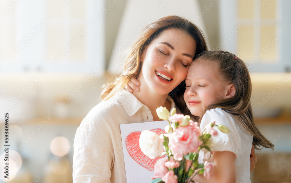 Daughters giving mother bouquet of flowers.