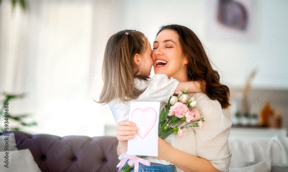 Daughter giving mother bouquet of flowers.