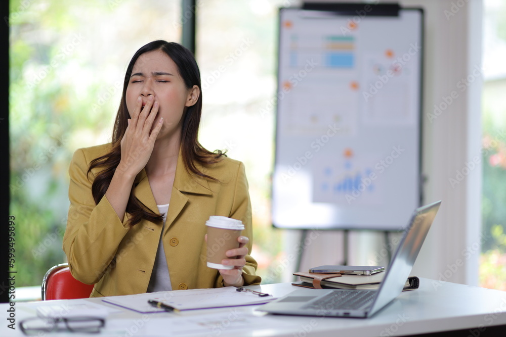 Woman stretching during break time while working at desk in office.