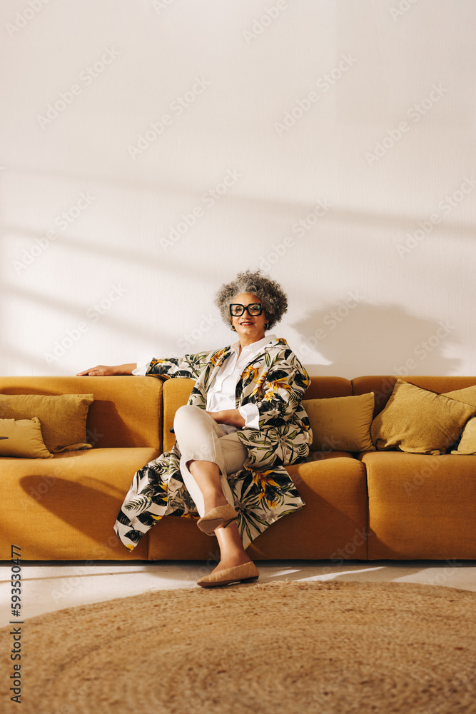 Grey-haired businesswoman sitting on a couch in a lobby