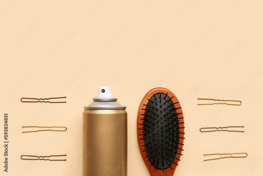 Composition with bottle of hair spray, brush and pins on color background