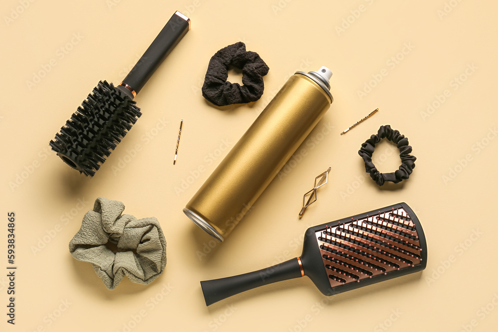 Composition with bottle of hair spray, brushes and accessories on color background