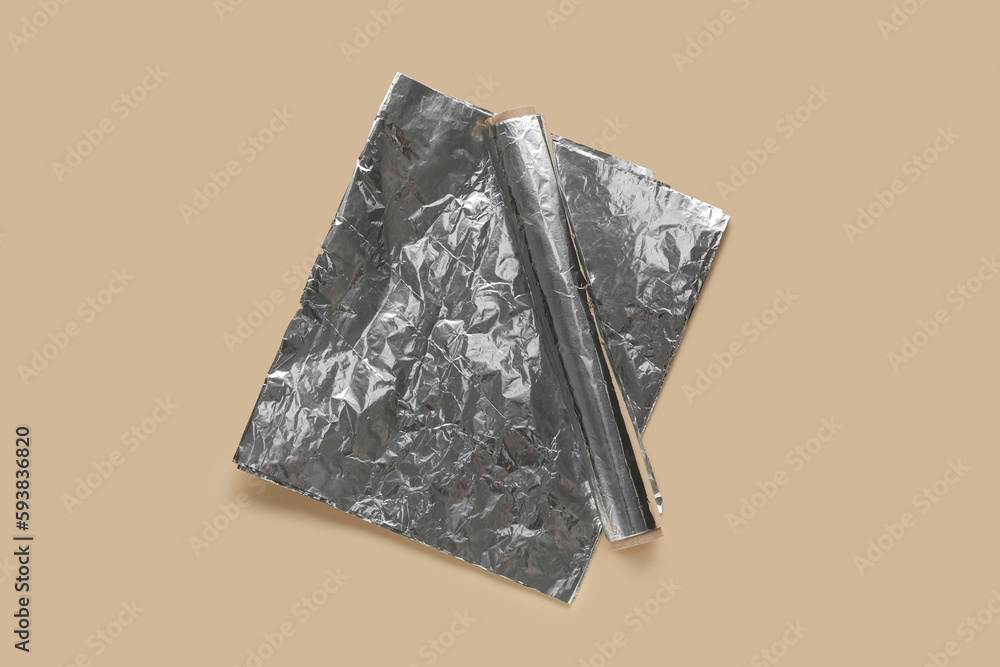 Aluminium foil roll on color background