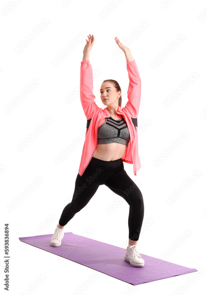 Sporty young woman balancing on white background