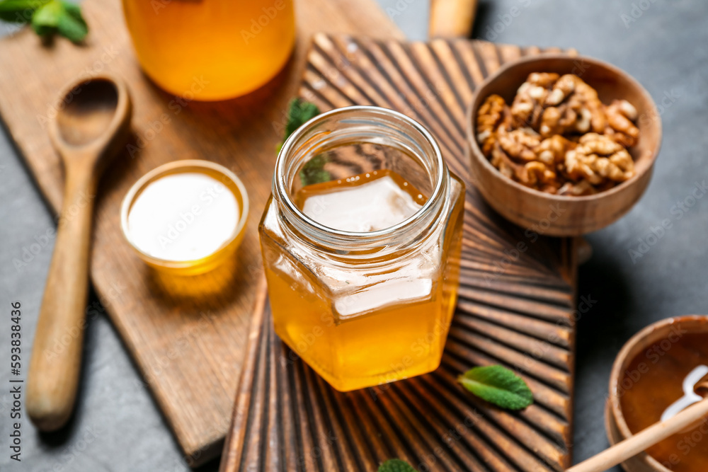 Jar of sweet honey on dark background