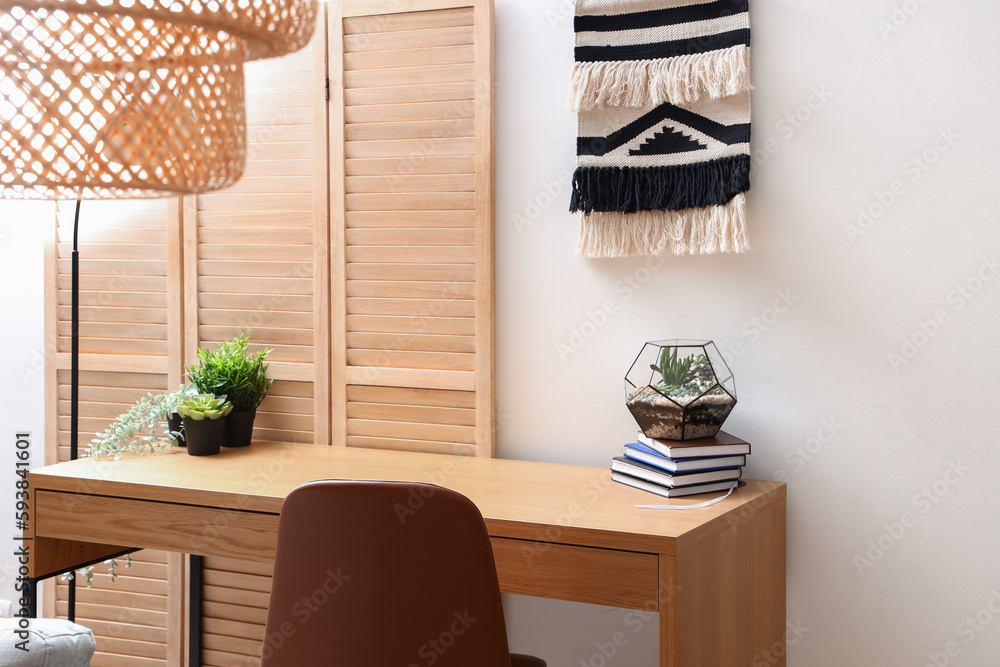 Interior of light office with modern workplace and houseplants