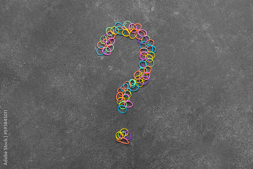 Question mark made of rubber bands on dark background