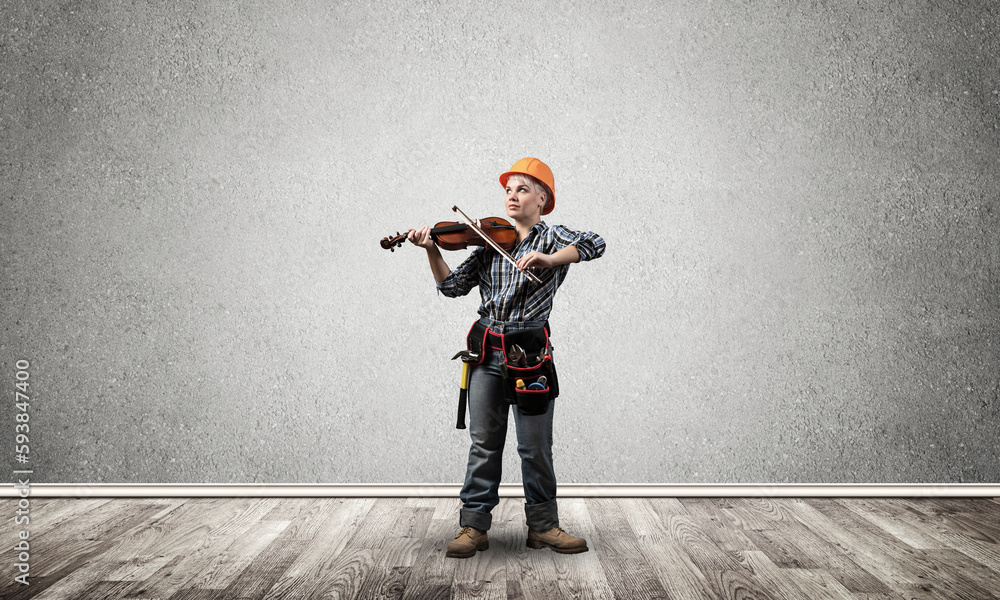 Beautiful woman in safety helmet playing violin