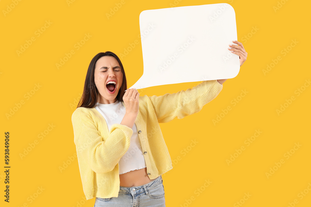 Young woman with blank speech bubble on yellow background