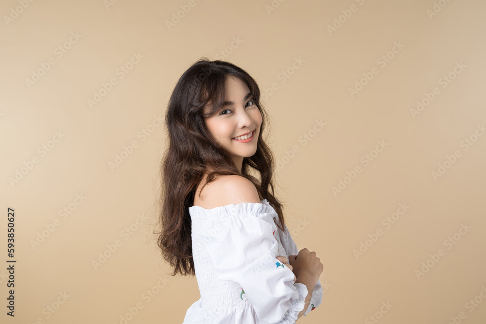 Portrait young Asian woman in cute dress isolated on brown background.