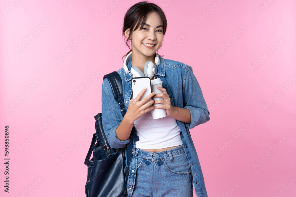 Portrait of young Asian woman student standing with smartphone coffee and backpack.College Teenager 