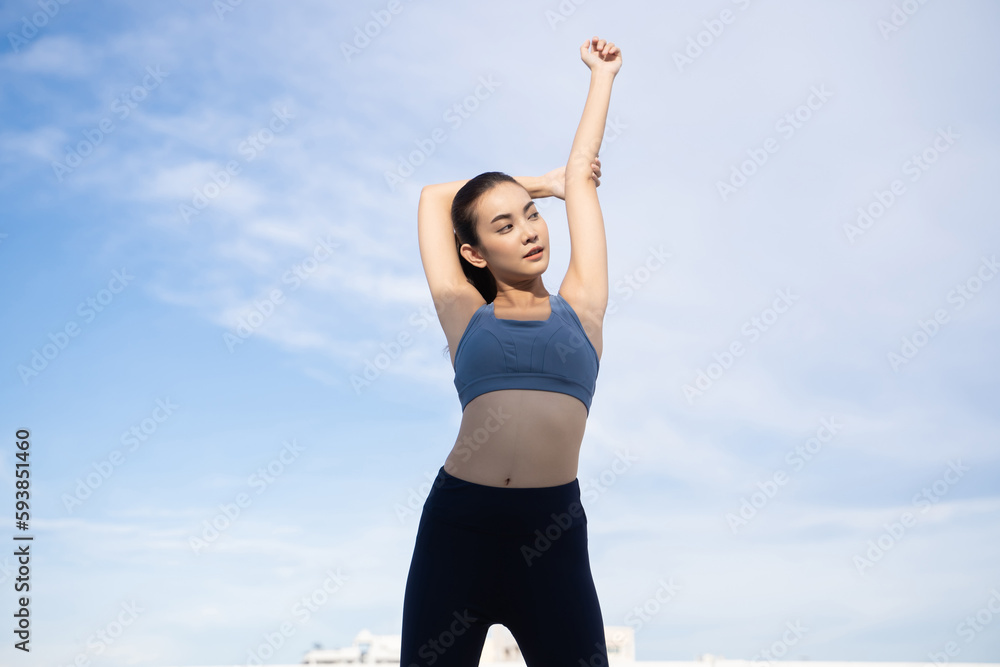 Young beauty Asian woman stretching workout outdoor rooftop. She warming up