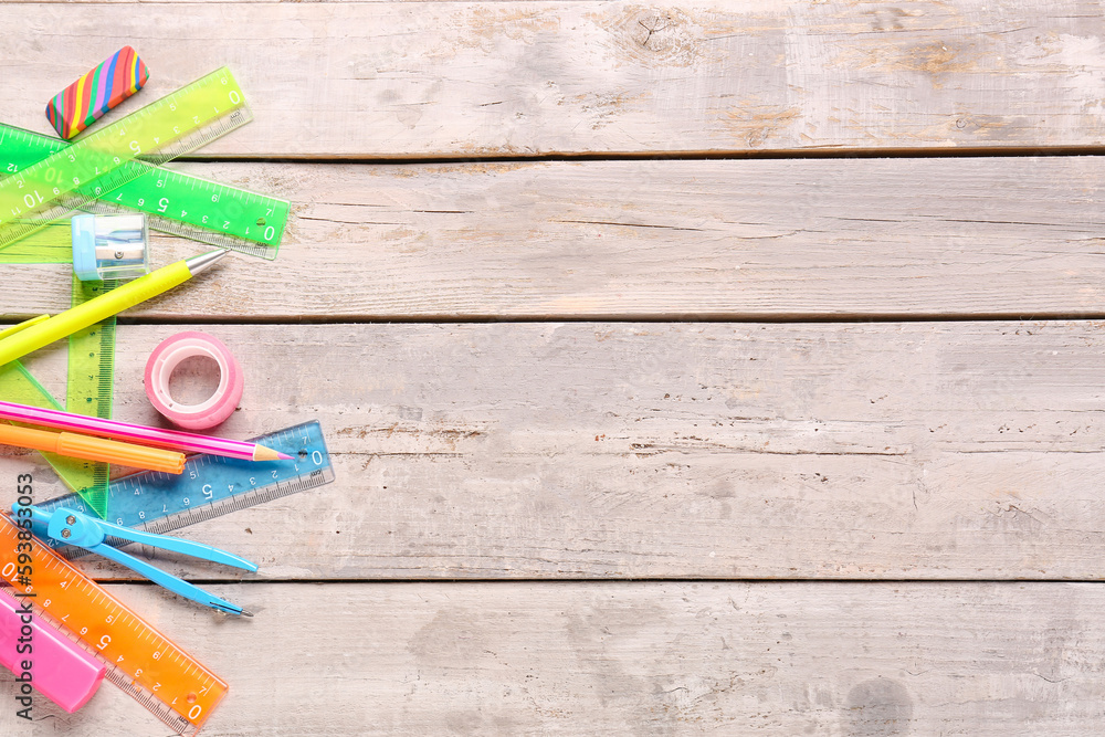 Colorful stationery supplies on wooden background