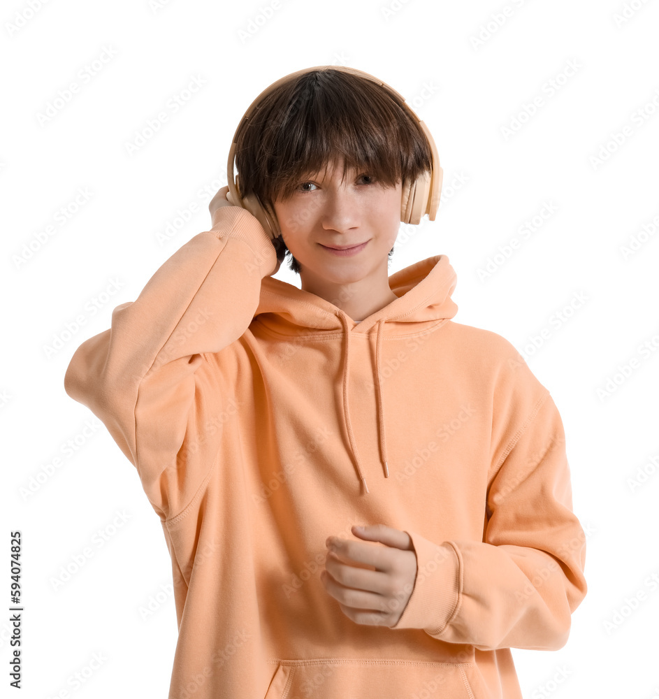 Teenage boy with headphones listening to music on white background