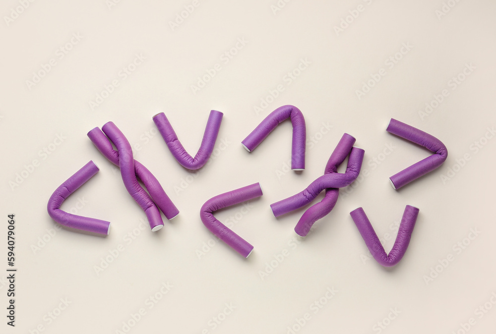 Hair curlers on light background