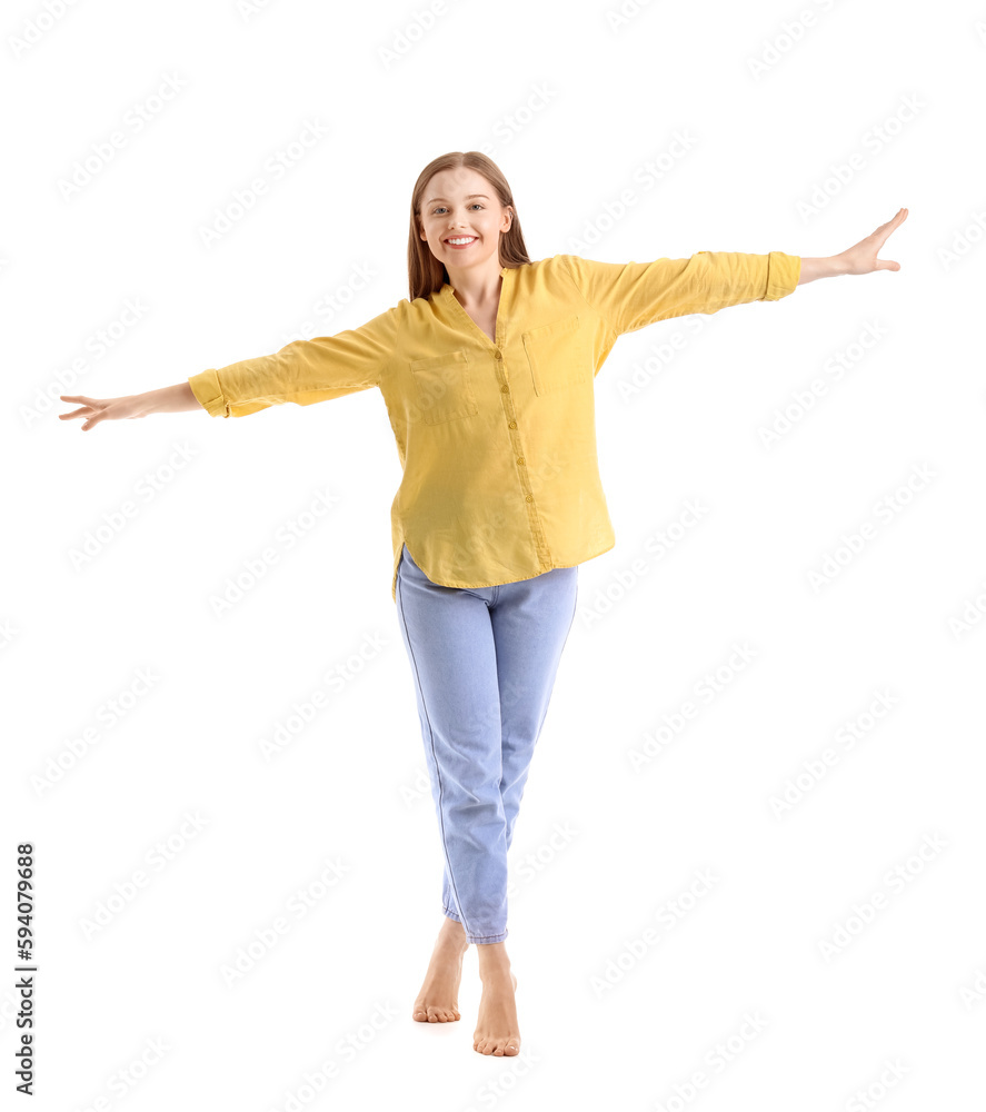 Young woman balancing on white background