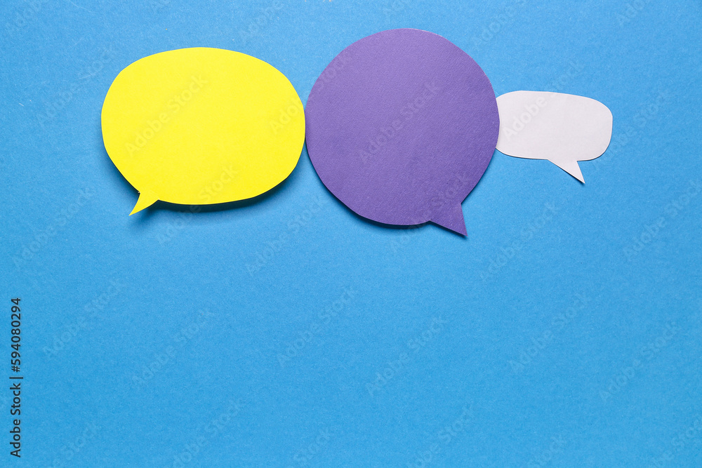 Blank paper speech bubbles on blue background