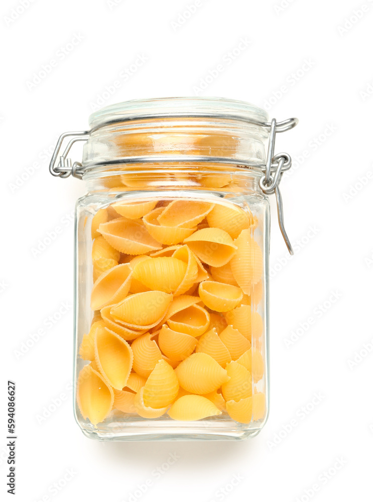 Jar of raw conchiglie pasta isolated on white background