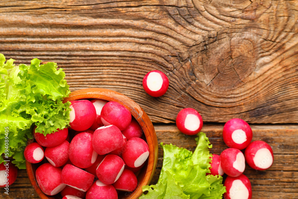 Bowl with fresh radish on wooden background