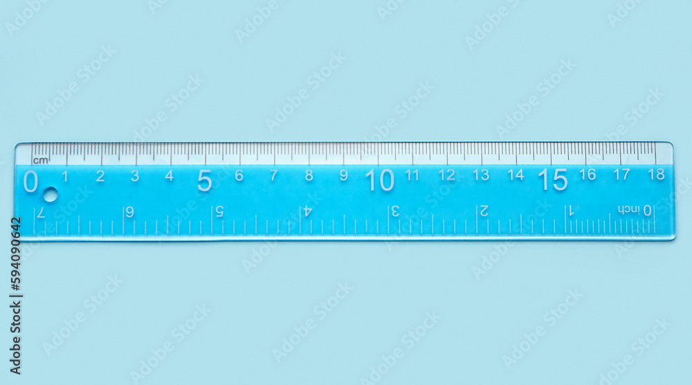 Blue plastic ruler on color background