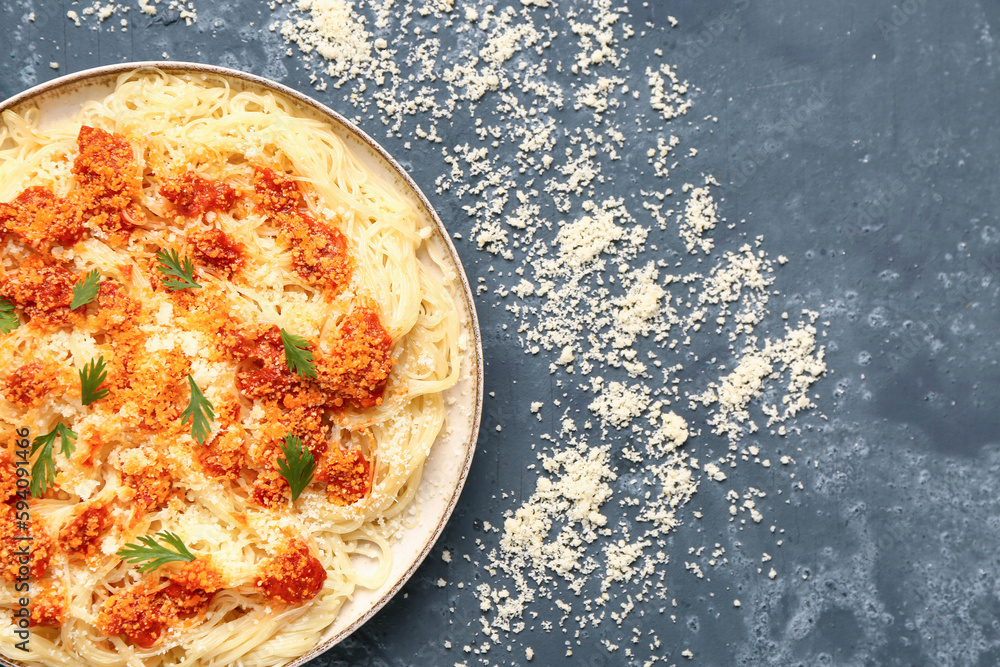 Plate of tasty Italian pasta with Parmesan cheese on blue background, closeup