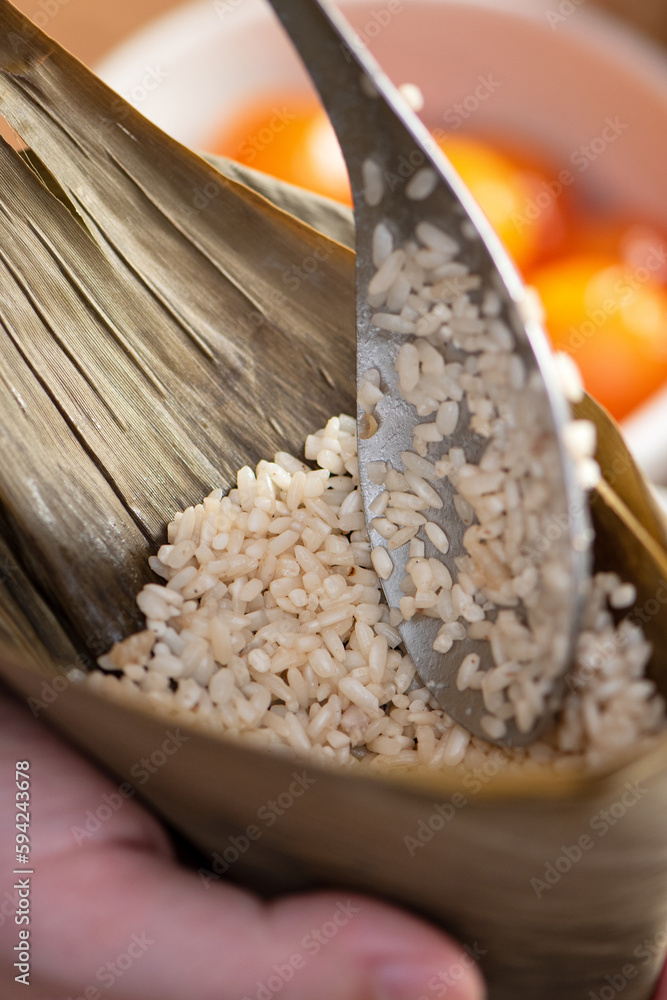 Making zongzi food - preparing and wrapping Chinese rice dumpling.