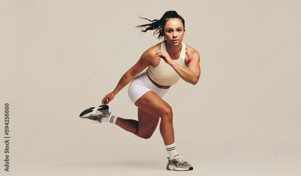 Intense workout session in a studio: Sportswoman doing strength training exercises