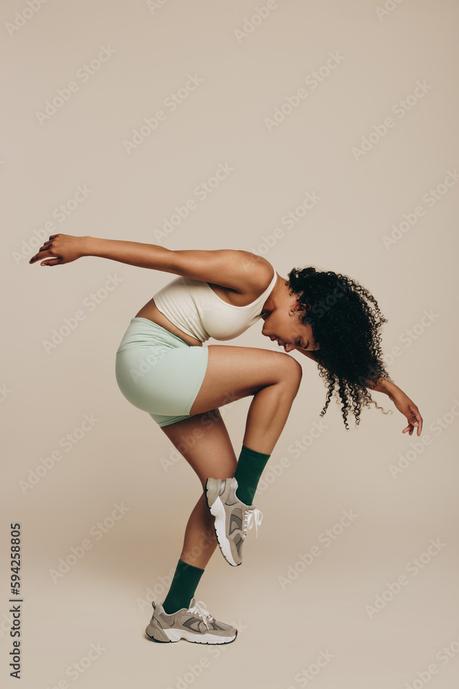 Balance and flexibility: Fit woman performing a workout pose