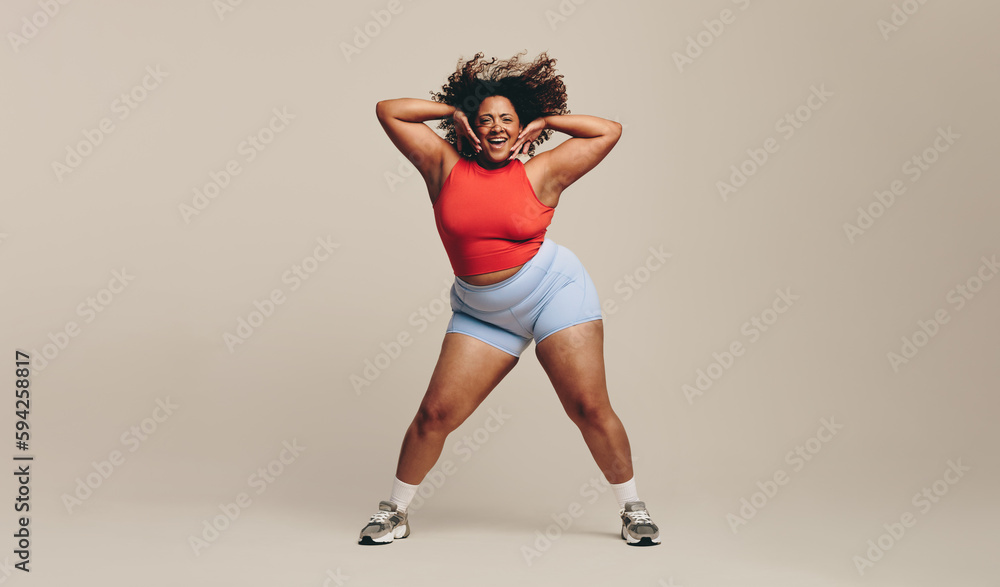 Fun and body movement: Fit woman enjoying a dance workout in a studio