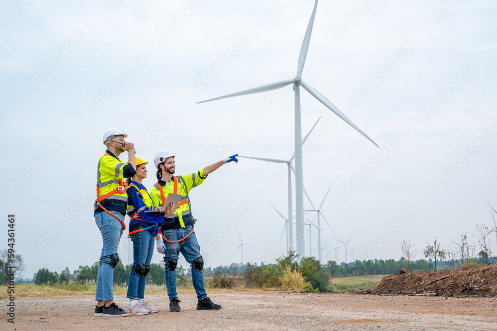 Group of engineers planning discuss project ann working in wind turbine farm,Sustainable future.