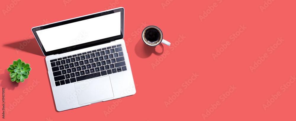 Laptop computer with a coffee cup from above