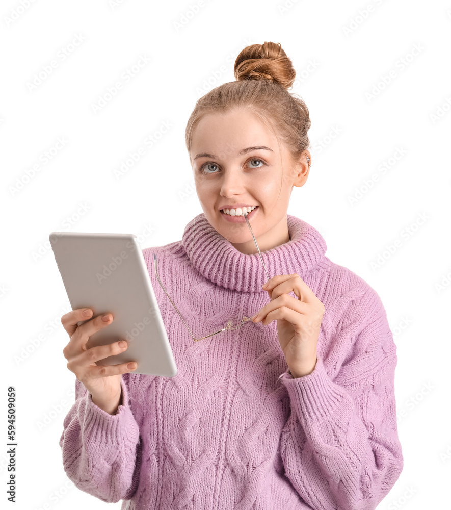 Young woman with tablet computer biting eyeglasses on white background