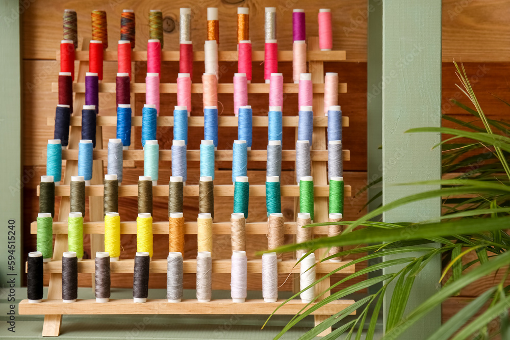 Stand with thread spools on shelf in atelier