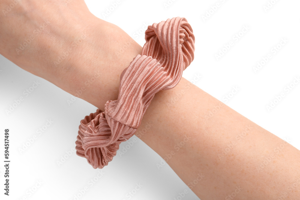 Female hand with stylish scrunchy on white background, closeup