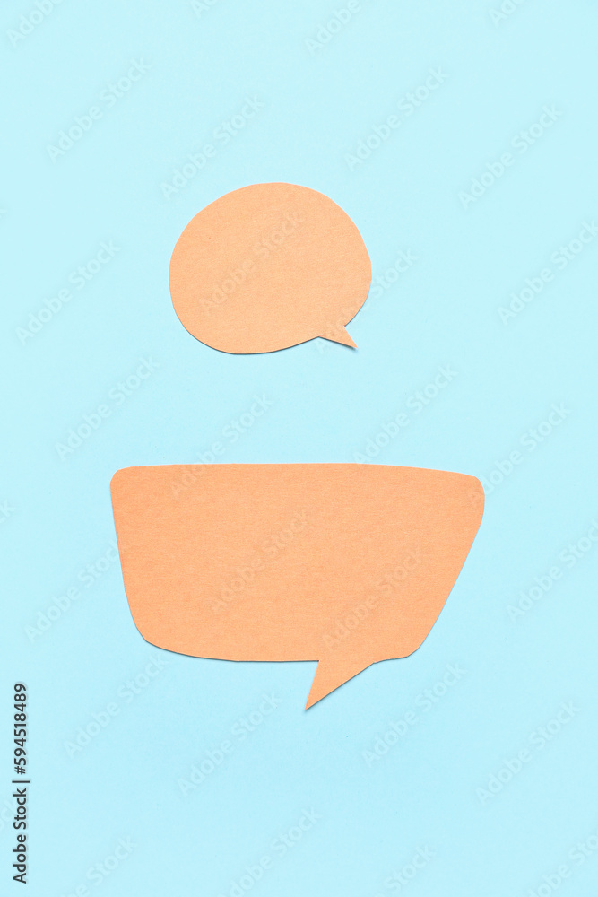 Blank paper speech bubbles on blue background