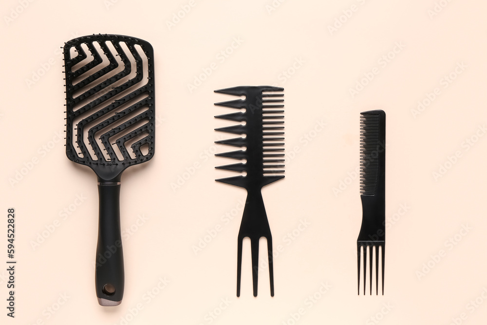 Hairdressers brushes on beige background