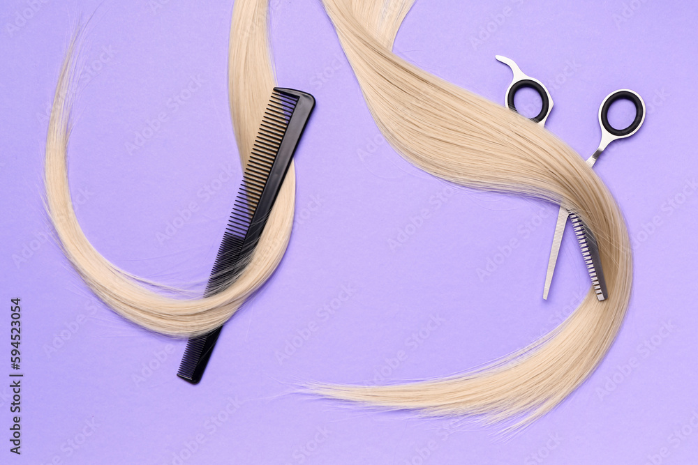 Hair strands with brush and scissors on violet background