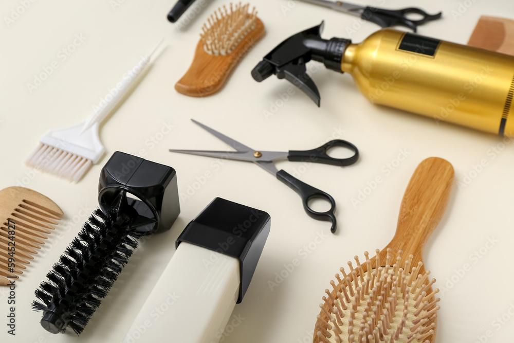 Composition with hairdressing accessories on light background, closeup